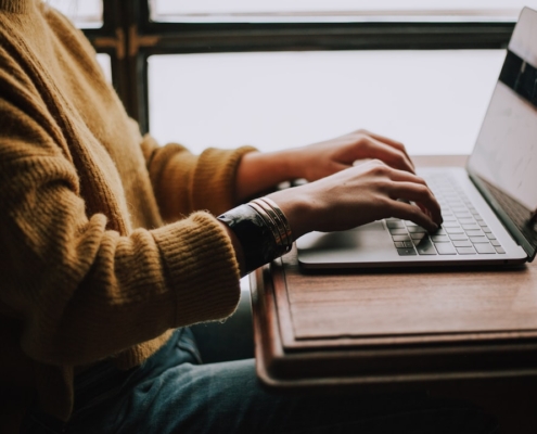 person sitting front of laptop